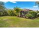 Expansive backyard with lush landscaping and screened patio at 12199 Sebring Ln, Venice, FL 34293