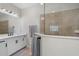 Modern bathroom with a large shower, double vanity, and marble countertops at 12199 Sebring Ln, Venice, FL 34293