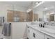 Bathroom with a large walk-in shower, double vanity, and modern fixtures at 12199 Sebring Ln, Venice, FL 34293