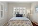 Guest bedroom with a queen-size bed and window shutters at 12199 Sebring Ln, Venice, FL 34293