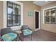 Covered entry with seating area, adding to the home's welcoming atmosphere at 12199 Sebring Ln, Venice, FL 34293