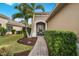 Brick walkway to covered entryway with seating area, offering curb appeal at 12199 Sebring Ln, Venice, FL 34293