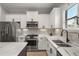 Modern kitchen with stainless steel appliances and white shaker cabinets at 12199 Sebring Ln, Venice, FL 34293