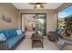 Comfortable screened patio with seating and view of the living room at 12199 Sebring Ln, Venice, FL 34293