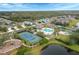 Aerial view of community pool, tennis courts, and homes at 12240 Whisper Lake Dr, Bradenton, FL 34211