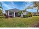 Home with large backyard, screened patio, and palm trees at 12240 Whisper Lake Dr, Bradenton, FL 34211