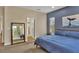 Spacious bedroom with large bed, mirror, and ocean-themed art at 12240 Whisper Lake Dr, Bradenton, FL 34211