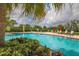 Sparkling community pool surrounded by lush landscaping at 12240 Whisper Lake Dr, Bradenton, FL 34211