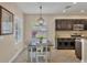 Bright dining room with table and chairs near kitchen and window at 12240 Whisper Lake Dr, Bradenton, FL 34211