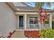 Covered front porch with rocking chairs and lush landscaping at 12240 Whisper Lake Dr, Bradenton, FL 34211
