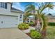 Landscaped front yard with palm trees and walkway to the house at 12240 Whisper Lake Dr, Bradenton, FL 34211