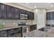 Modern kitchen with dark wood cabinets, granite countertops, and a gas range at 12240 Whisper Lake Dr, Bradenton, FL 34211