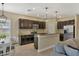 Modern kitchen with dark cabinets, granite countertops, and stainless steel appliances at 12240 Whisper Lake Dr, Bradenton, FL 34211