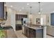 Open kitchen with island, granite counters, stainless steel appliances and breakfast bar at 12240 Whisper Lake Dr, Bradenton, FL 34211