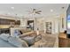 Open-concept living room with kitchen views, neutral colors, and a ceiling fan at 12240 Whisper Lake Dr, Bradenton, FL 34211