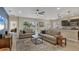Spacious living room featuring comfortable sofas, large windows, and a view to the backyard at 12240 Whisper Lake Dr, Bradenton, FL 34211