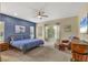 Spacious main bedroom with a king-size bed, wood furniture, and a blue accent wall at 12240 Whisper Lake Dr, Bradenton, FL 34211