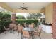 Outdoor kitchen and dining area with grills and seating at 12240 Whisper Lake Dr, Bradenton, FL 34211