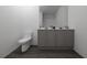 Modern bathroom with double vanity, dark floors, and a clean design at 13029 Cedar Elm Lane, Parrish, FL 34219