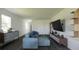Open living area with sectional sofa, built-in shelving, and dark hardwood floors at 13029 Cedar Elm Lane, Parrish, FL 34219