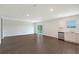 Spacious living room with dark flooring and sliding glass doors to backyard at 13033 Cedar Elm Lane, Parrish, FL 34219