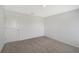Simple bedroom with neutral walls, carpeting, and a door at 13115 Cedar Elm Lane, Parrish, FL 34219