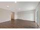 Spacious living room with sliding glass doors and dark wood-look floors at 13115 Cedar Elm Lane, Parrish, FL 34219
