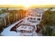 Luxury waterfront home with pool and private dock at sunset at 144 N Casey Key Rd, Osprey, FL 34229
