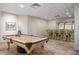 Basement bar with seating and display cabinetry at 144 N Casey Key Rd, Osprey, FL 34229
