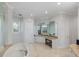 Elegant bathroom with soaking tub, double vanity, and separate shower at 144 N Casey Key Rd, Osprey, FL 34229
