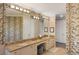 Double vanity bathroom with marble countertop and elegant wallpaper at 144 N Casey Key Rd, Osprey, FL 34229