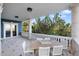 Covered patio with dining table and stunning water views at 144 N Casey Key Rd, Osprey, FL 34229