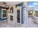 Outdoor patio with fireplace, seating, and water views at 144 N Casey Key Rd, Osprey, FL 34229