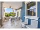 Covered patio with seating area and tranquil water views at 144 N Casey Key Rd, Osprey, FL 34229