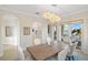 Elegant dining room featuring a large wooden table and access to kitchen at 144 N Casey Key Rd, Osprey, FL 34229