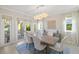 Bright dining room with hardwood floors and access to a balcony at 144 N Casey Key Rd, Osprey, FL 34229