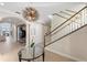 Elegant entryway with a grand staircase and chandelier at 144 N Casey Key Rd, Osprey, FL 34229