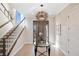 Bright and spacious entryway with elegant staircase at 144 N Casey Key Rd, Osprey, FL 34229