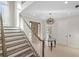 Grand entryway with staircase, chandelier, and glass-top table at 144 N Casey Key Rd, Osprey, FL 34229