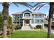 Stunning waterfront home with a grand entrance and lush landscaping at 144 N Casey Key Rd, Osprey, FL 34229