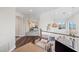 Elegant hallway with hardwood floors and access to a bedroom suite, showcasing the home's sophisticated design at 144 N Casey Key Rd, Osprey, FL 34229