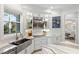 Modern kitchen with stainless steel appliances and custom cabinetry at 144 N Casey Key Rd, Osprey, FL 34229