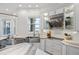 Modern kitchen features stainless steel appliances and marble countertops at 144 N Casey Key Rd, Osprey, FL 34229