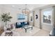 Comfortable living room with a blue velvet sofa and large windows at 144 N Casey Key Rd, Osprey, FL 34229