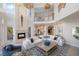 High-ceilinged living room with an open floor plan and fireplace at 144 N Casey Key Rd, Osprey, FL 34229