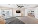 Main bedroom with stunning water views, TV, and access to home office at 144 N Casey Key Rd, Osprey, FL 34229
