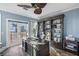 Home office with built-in bookcases and water views at 144 N Casey Key Rd, Osprey, FL 34229