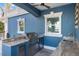 Granite-topped outdoor kitchen with grill and sink at 144 N Casey Key Rd, Osprey, FL 34229
