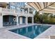 Resort-style pool and spa with patio and bar at 144 N Casey Key Rd, Osprey, FL 34229
