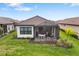 Home features a screened patio and grassy backyard at 16127 Fortezza Dr, Bradenton, FL 34211